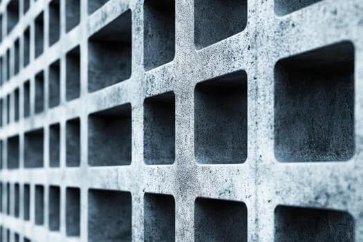 Textured precision concrete blocks stacked in a production yard